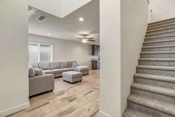 a living room with furniture and stairs