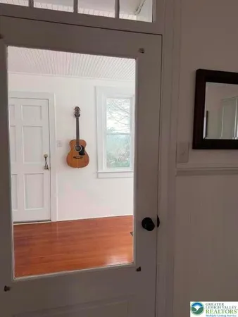 a workspace with furniture hardwood floor and a window