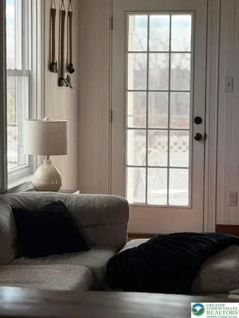 a bedroom with furniture and a window