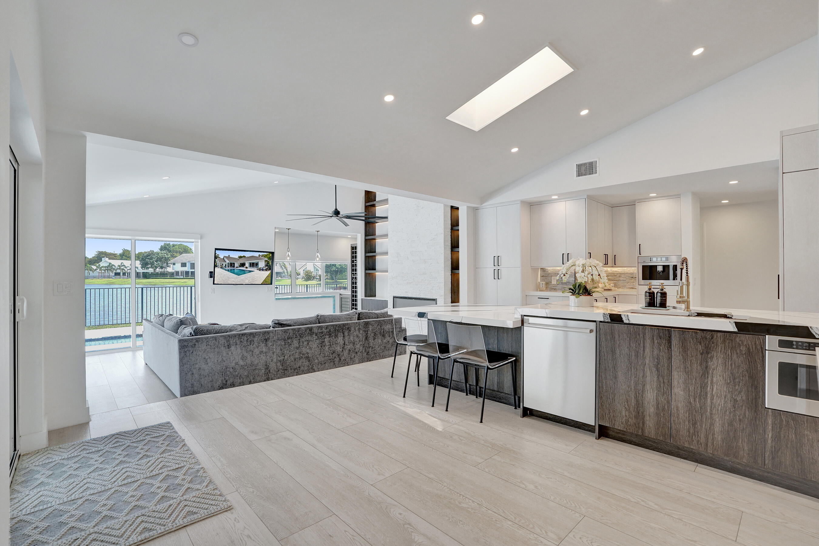 4130 Georges Way Boca Raton, FL 33434 - Photo 23 of 69 a kitchen with stainless steel appliances kitchen island granite countertop a table and chairs in it