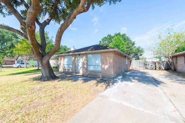 a view of a house with a tree in the background