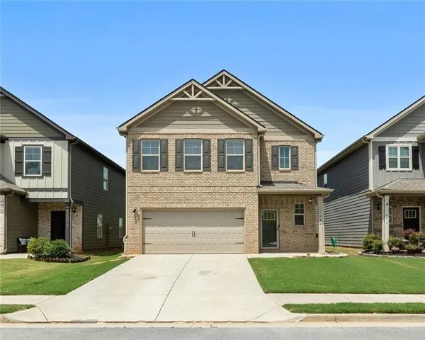 a front view of a house with a yard
