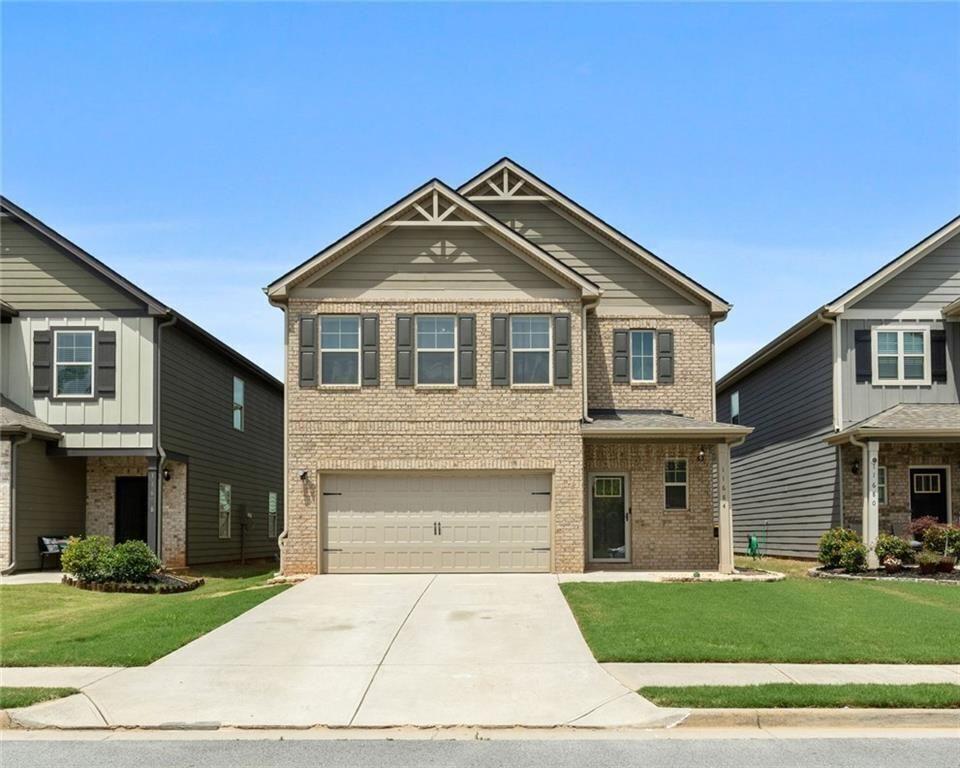 a front view of a house with a yard