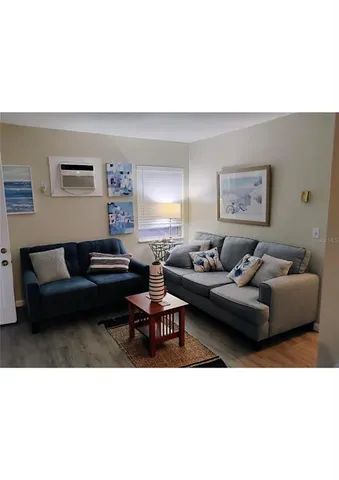 a living room with furniture and a lamp