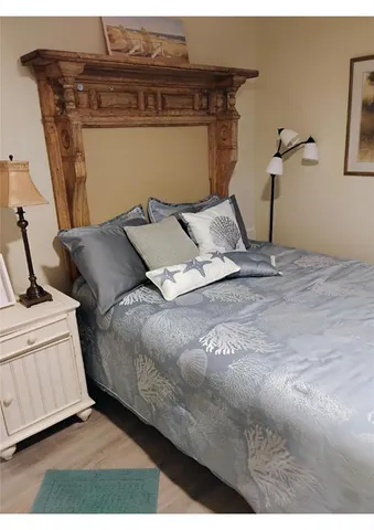 a bed sitting in a bedroom next to a window