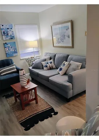 a living room with furniture and a night stand