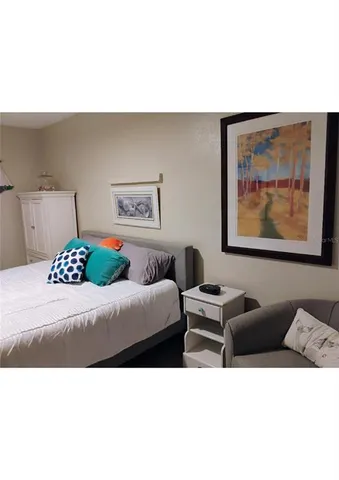 a living room with furniture and wall paintings