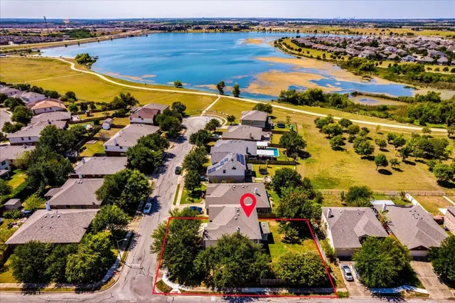 an aerial view of residential houses with outdoor space