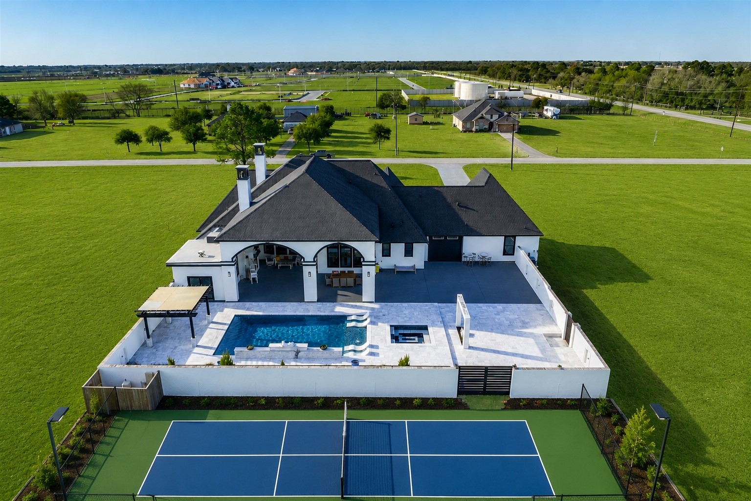 4821 Walters Road Richmond, TX 77469 - Photo 12 of 50 Aerial view showcasing the full scope of this custom estate, featuring a resort-style pool, sunken fire lounge, pergola, and expansive outdoor living areas set on 3.117 unrestricted acres.