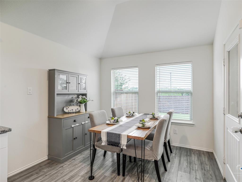 4517 Ashmark Road Aubrey, TX 76227 - Photo 20 of 26 a view of a a dining room with furniture window and wooden floor