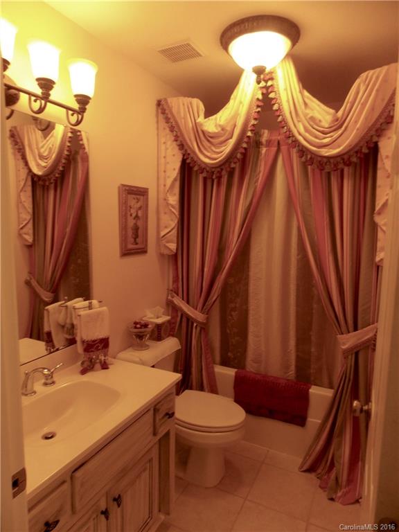 371 Sunset Road, Unit 16 Landrum, SC 29356 - Photo 22 of 24 a bathroom with a sink a toilet and a mirror