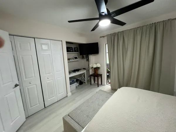 a bedroom with furniture and a ceiling fan