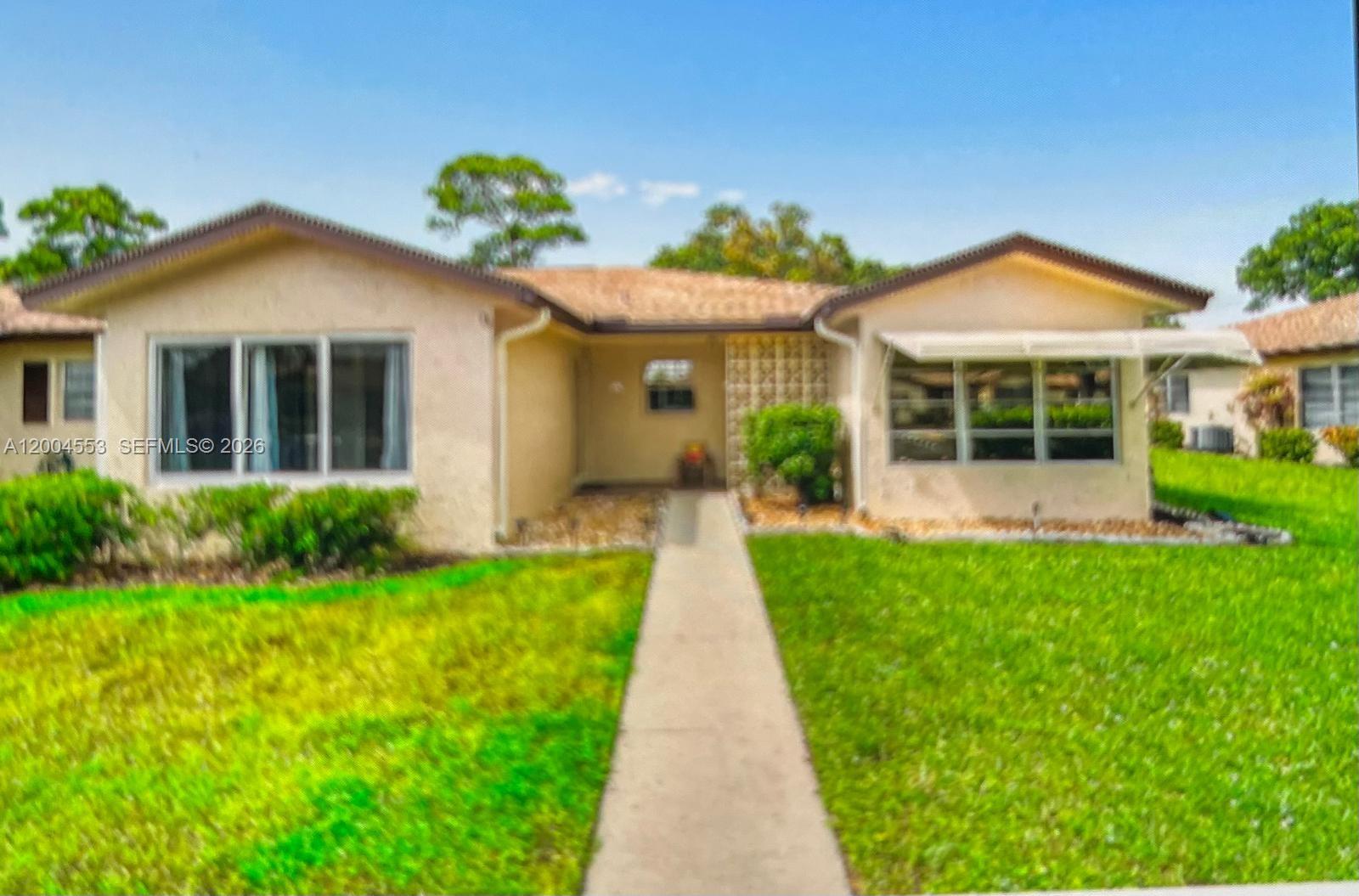 front view of a house with a yard