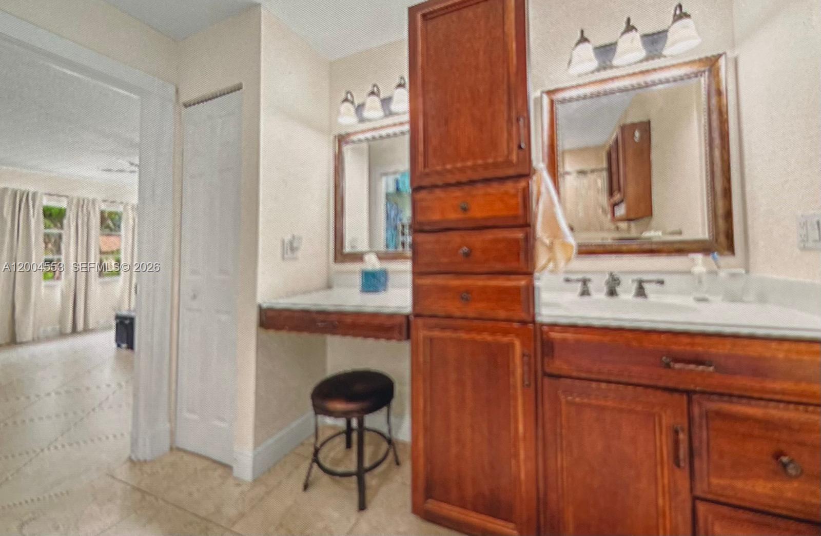 13990 Nesting Way, Unit C Delray Beach, FL 33484 - Photo 16 of 18 a bathroom with a sink and a mirror