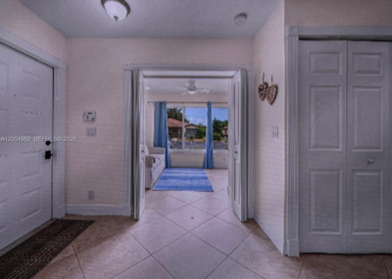 13990 Nesting Way, Unit C Delray Beach, FL 33484 - Photo 5 of 18 a view of a hallway with wooden shelves