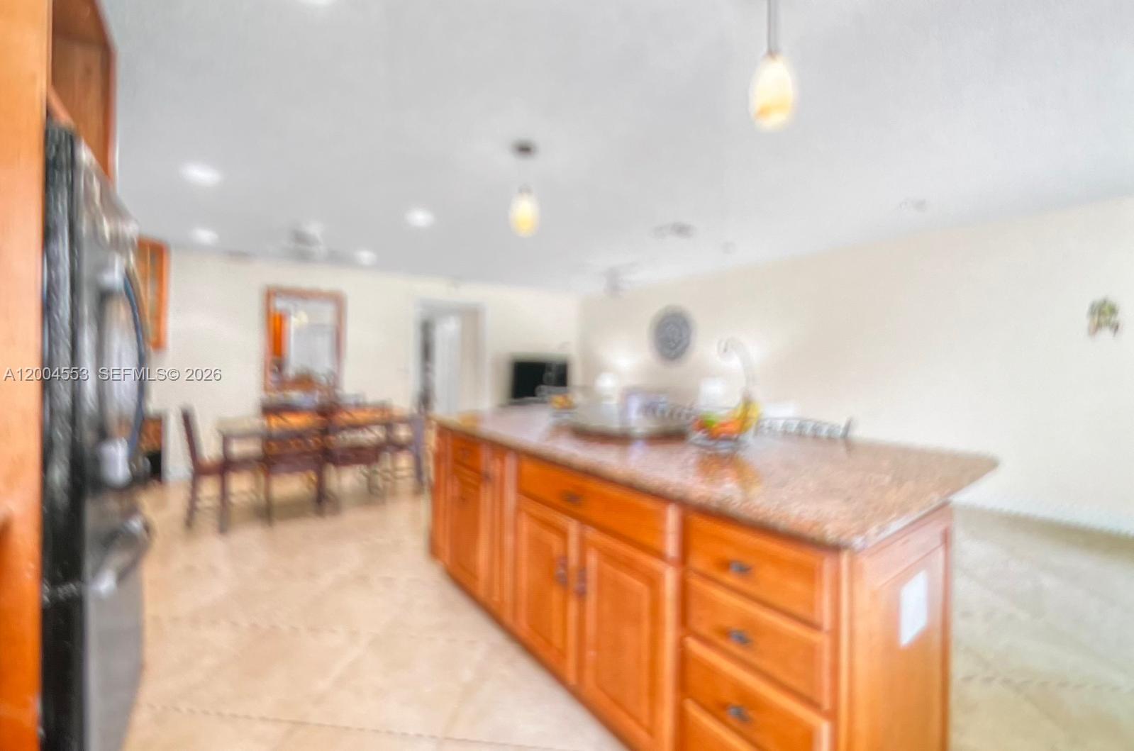 13990 Nesting Way, Unit C Delray Beach, FL 33484 - Photo 9 of 18 a kitchen with stainless steel appliances granite countertop a sink and cabinets