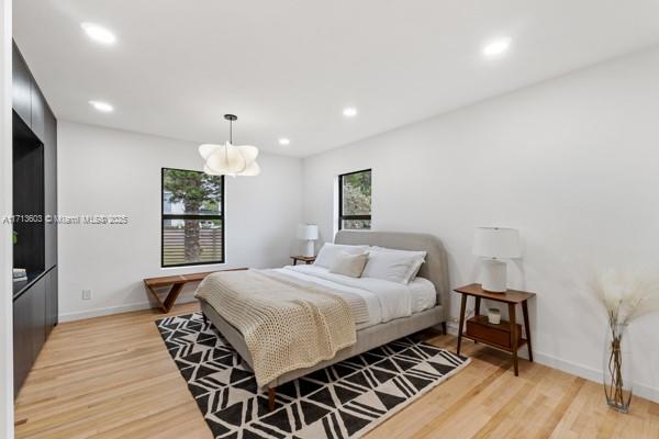 1024 Southwest 23rd Road Miami, FL 33129 - Photo 13 of 33 a bedroom with a bed and wooden floor