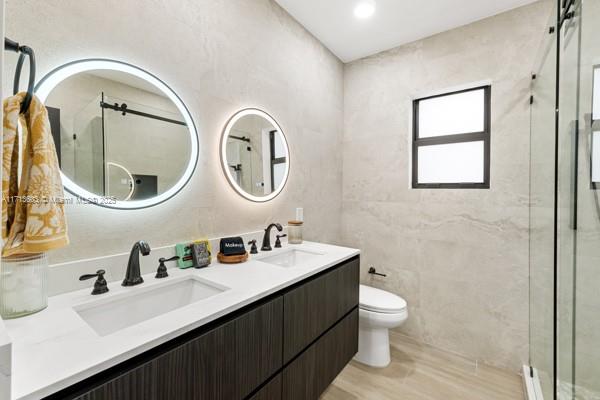 1024 Southwest 23rd Road Miami, FL 33129 - Photo 18 of 33 a bathroom with a double vanity sink mirror and toilet