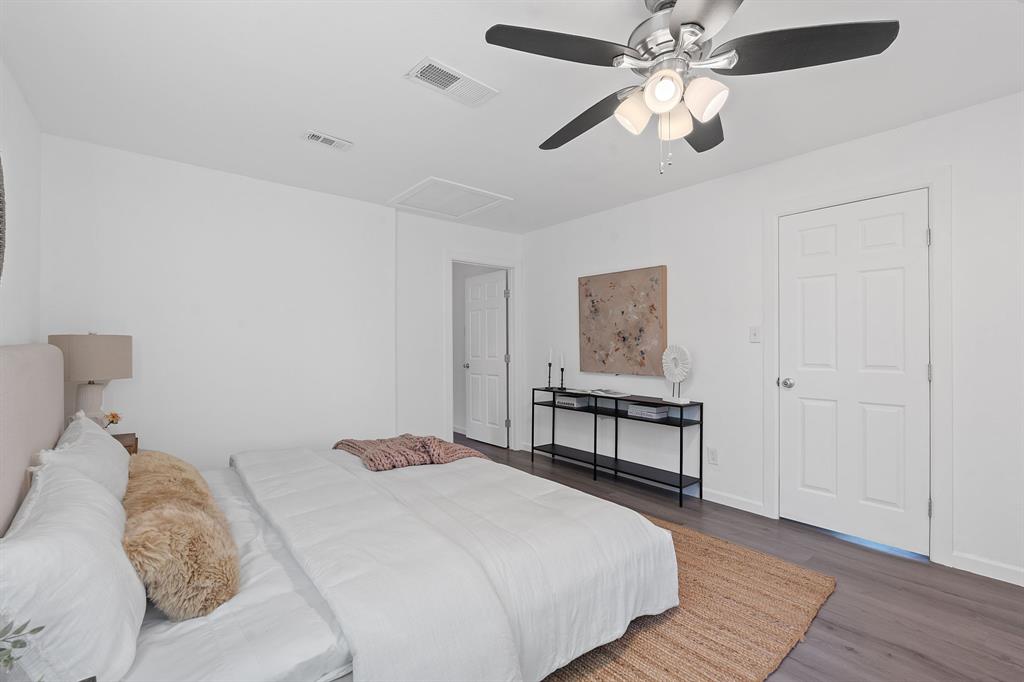 1156 Nickols Avenue Austin, TX 78721 - Photo 12 of 23 a bedroom with a bed and a chandelier