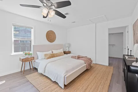 a bedroom with a bed and a chandelier