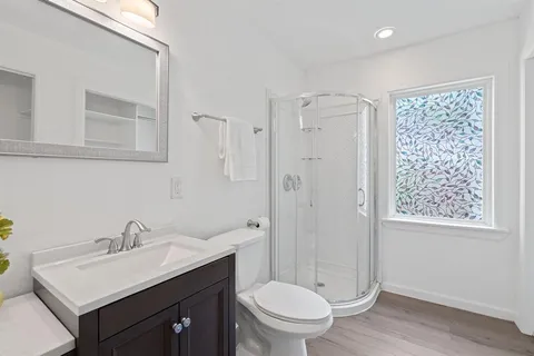 a bathroom with a sink toilet and shower