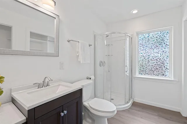 a bathroom with a sink toilet and shower