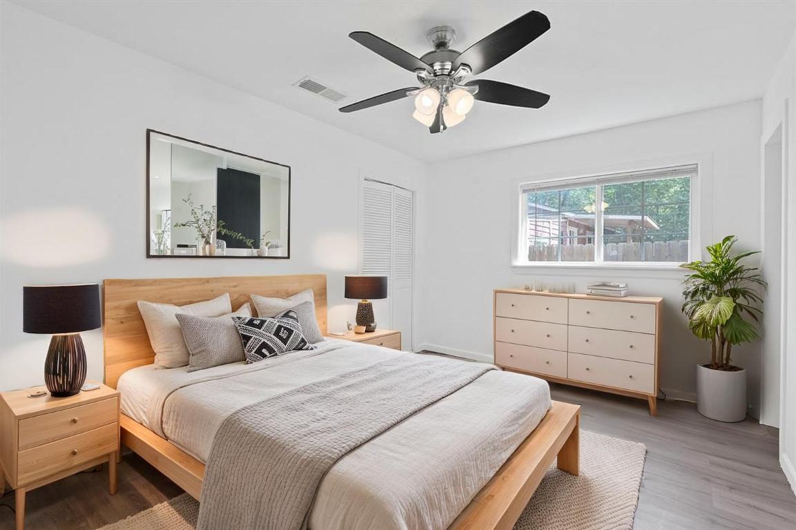 1156 Nickols Avenue Austin, TX 78721 - Photo 19 of 23 a bedroom with a bed and a chandelier