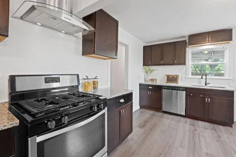 a living room with furniture a fireplace and a chandelier
