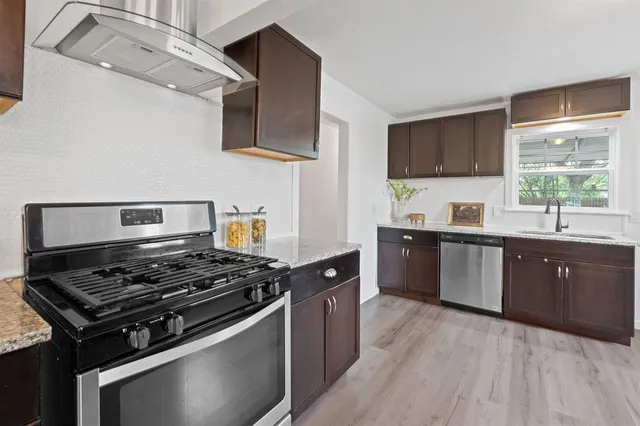 a living room with furniture a fireplace and a chandelier