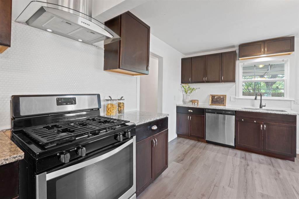 1156 Nickols Avenue Austin, TX 78721 - Photo 6 of 23 a kitchen with stainless steel appliances a sink dishwasher a stove and a microwave oven with cabinets