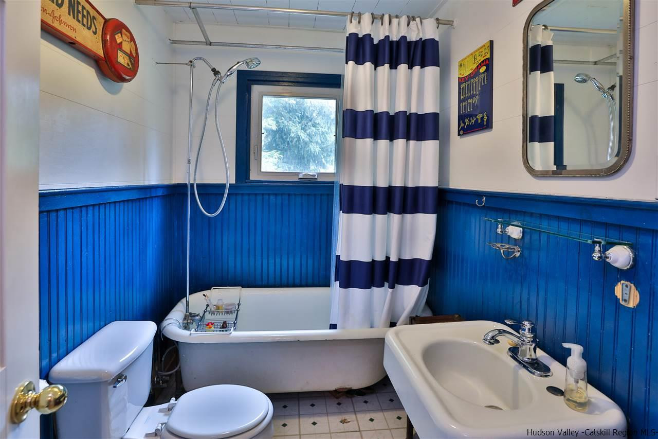 499 County Route 3 Fleischmanns, NY 12430 - Photo 23 of 25 a bathroom with a sink toilet a mirror and tub