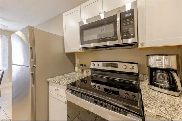 a stove top oven sitting inside of a kitchen