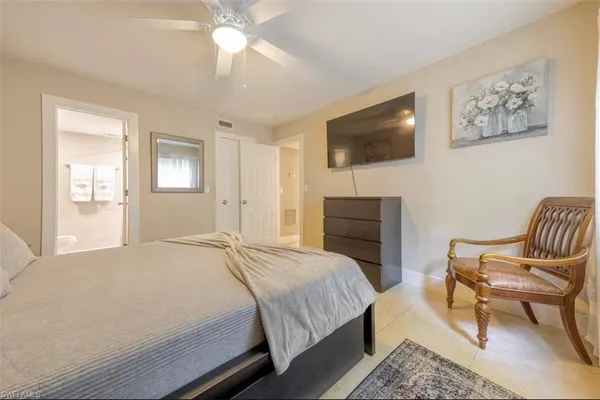 a bedroom with a bed and a chair