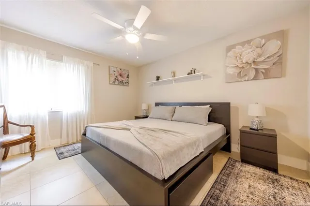 a bedroom with bed and a chandelier