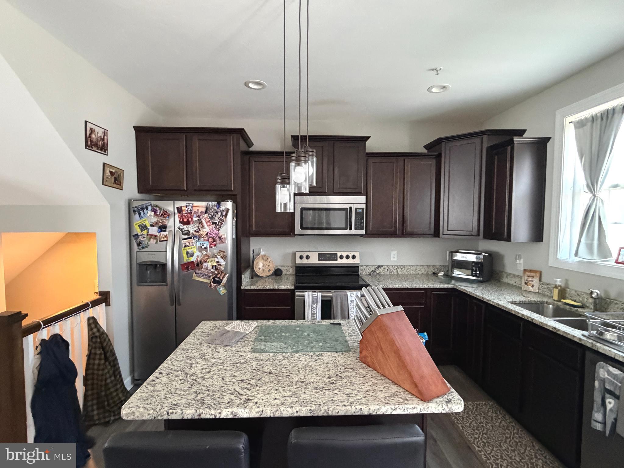 522 Charles Avenue Hanover, PA 17331 - Photo 18 of 59 a kitchen with stainless steel appliances granite countertop a sink stove and refrigerator
