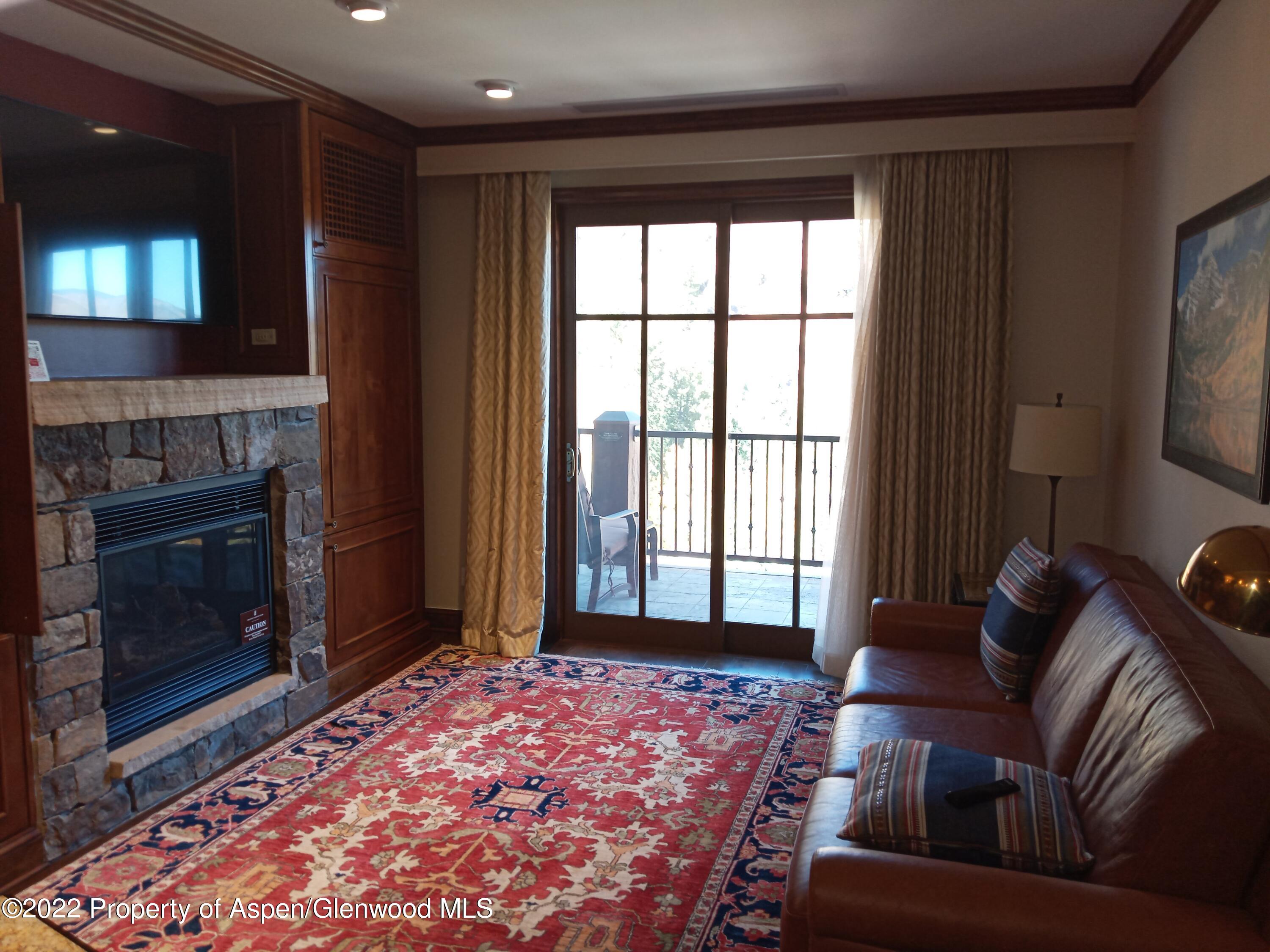 39 Boomerang Road, Unit 8412 SUMMER INTEREST 7 Aspen, CO 81611 - Photo 4 of 21 a living room with furniture and a fireplace