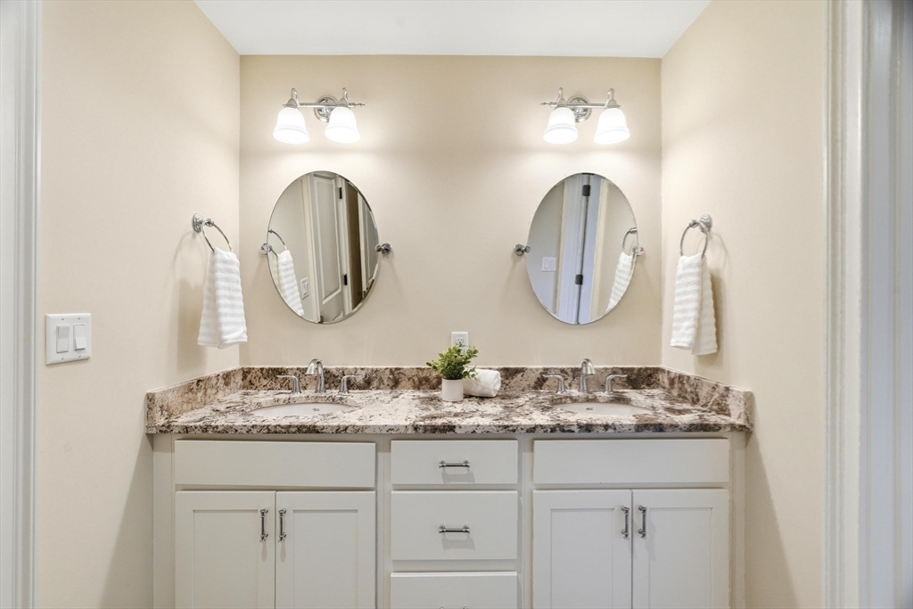 6 Flintlock Road Lexington, MA 02420 - Photo 25 of 39 a bathroom with double vanity sinks and a mirror