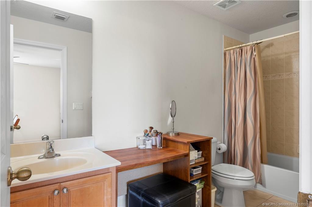 5321 Southeast Jennings Lane Stuart, FL 34997 - Photo 15 of 19 a bathroom with a sink toilet and a mirror