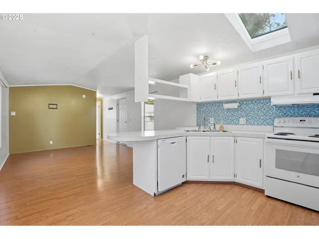 a kitchen with cabinets and wooden floor
