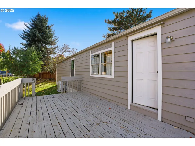 a view of a deck with wooden floor and fence with a yard