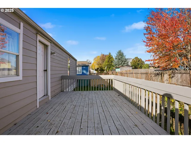 a view of deck with wooden floor and fence