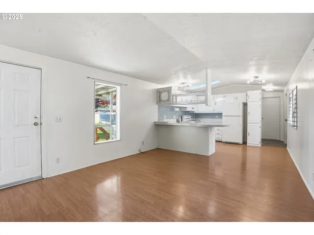 a view of a kitchen with a sink and a window