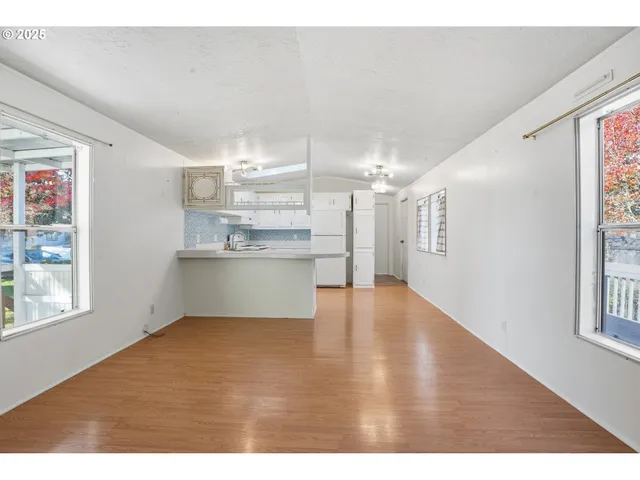 a view of kitchen with windows and cabinet