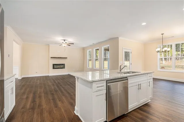 a open kitchen with a sink and dish washer