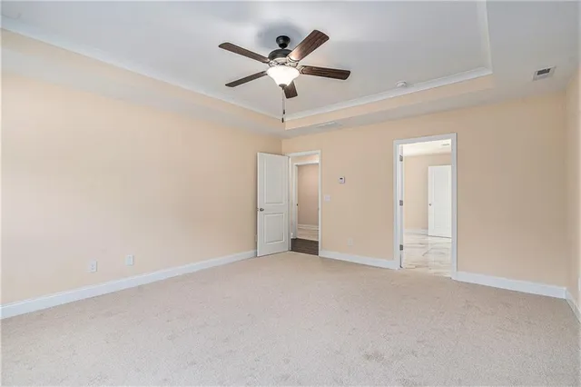 an empty room with closet and ceiling fan