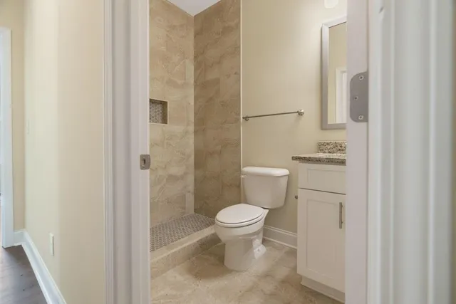 a bathroom with a toilet and a shower