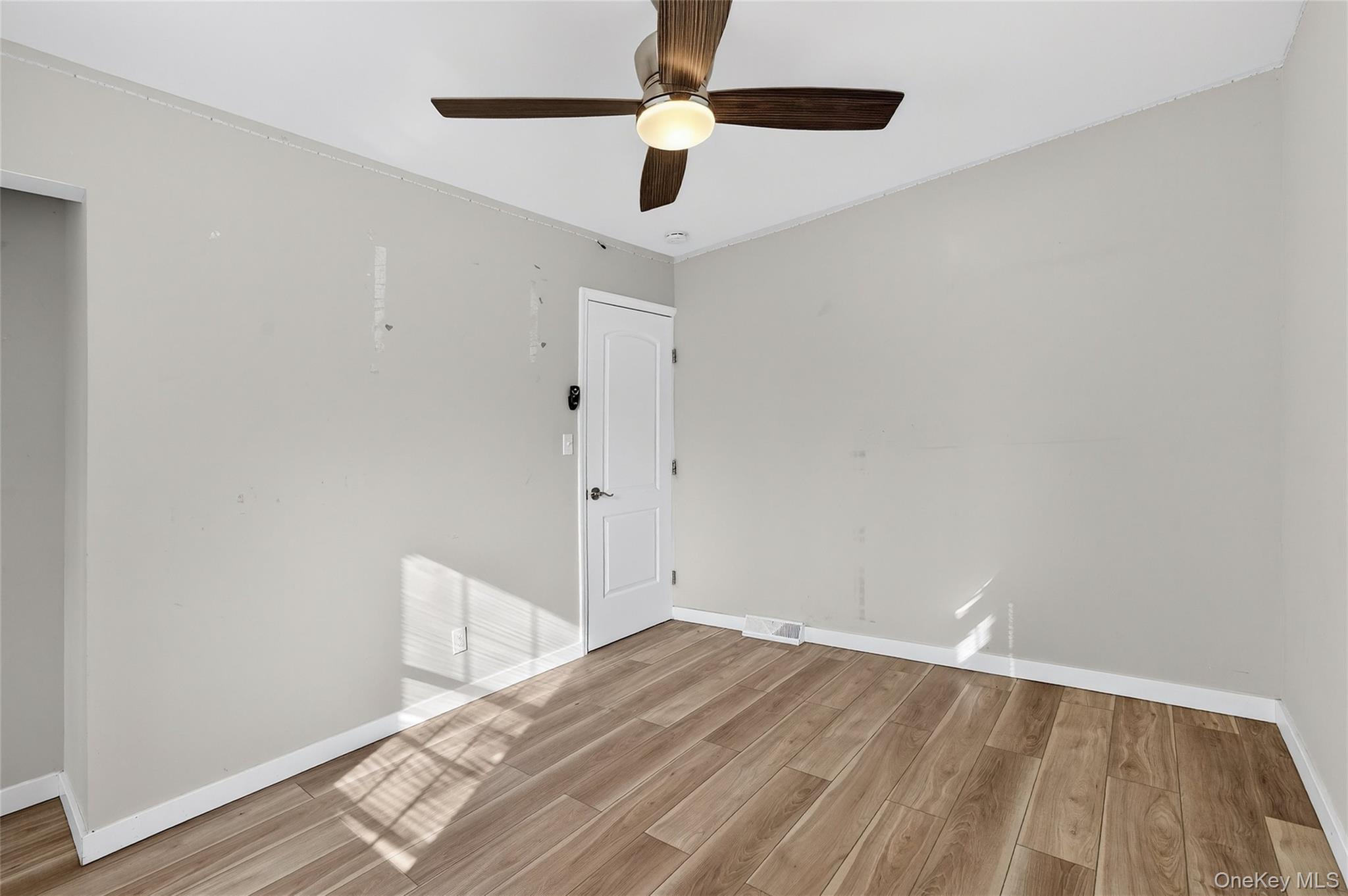 12 Revere Road Monroe, NY 10950 - Photo 23 of 30 Empty room with light wood finished floors, ceiling fan, and crown molding