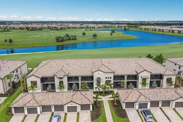 an aerial view of a house with a garden and lake view