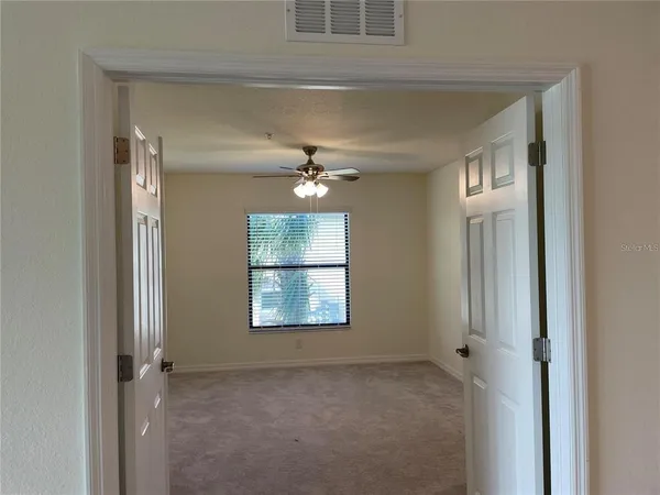 a view of an empty room with a window