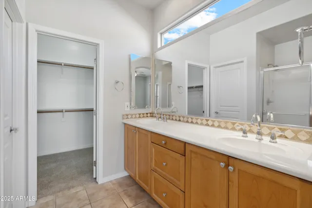 a bathroom with a double vanity sink and mirror